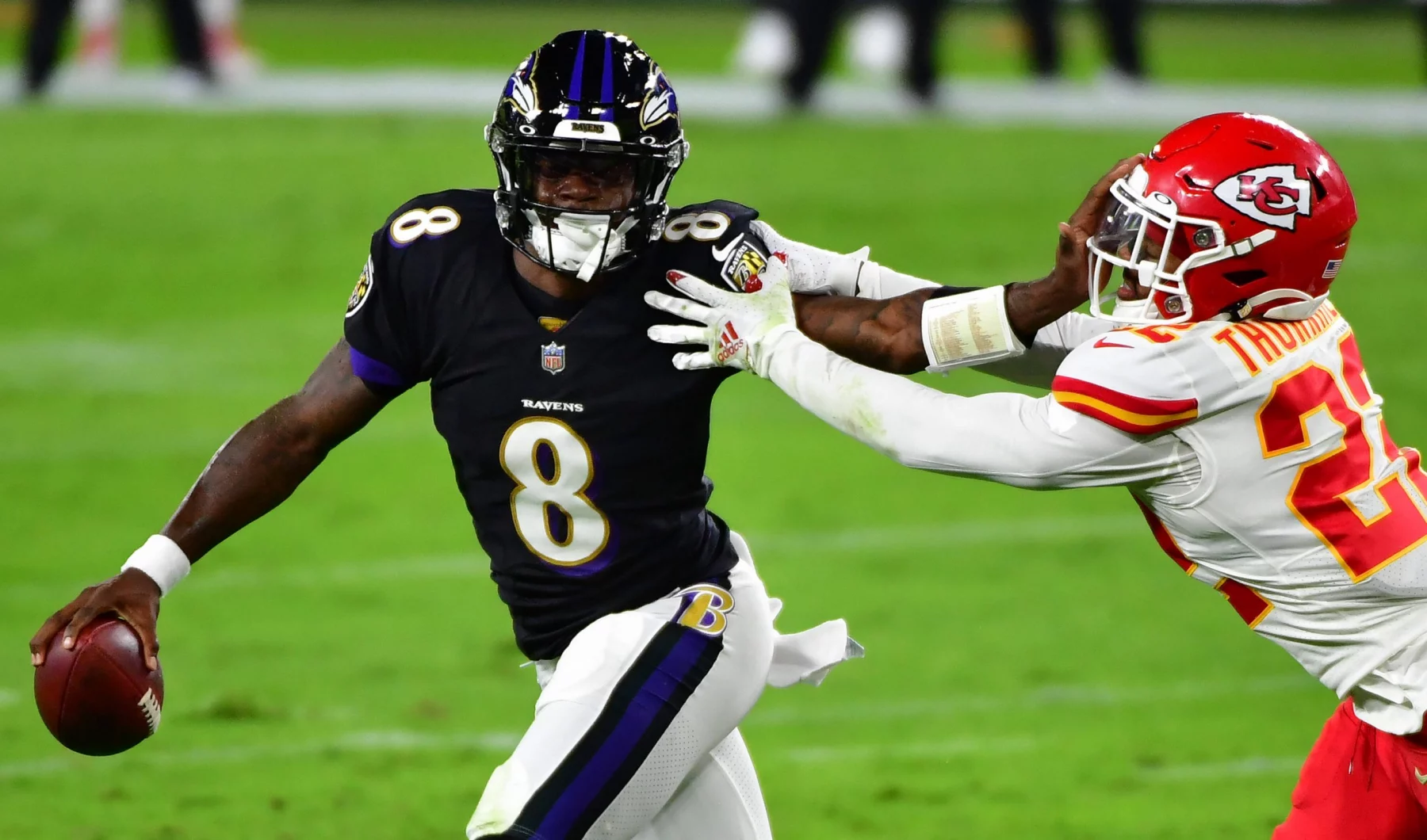 Baltimore Ravens quarterback Lamar Jackson (8) pushes Kansas City Chiefs safety Juan Thornhill (22) away during the firs