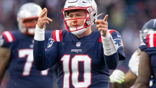 Road to NFL Playoffs - New England Patriots quarterback Mac Jones (10) holds up a finger after making