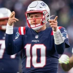 Road to NFL Playoffs - New England Patriots quarterback Mac Jones (10) holds up a finger after making