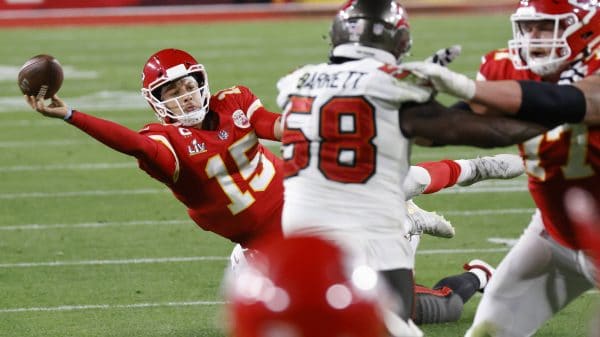 Kansas City Chiefs quarterback Patrick Mahomes (15) throws a desperation pass as he falls to the ground in the fourth qu