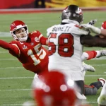 Kansas City Chiefs quarterback Patrick Mahomes (15) throws a desperation pass as he falls to the ground in the fourth qu