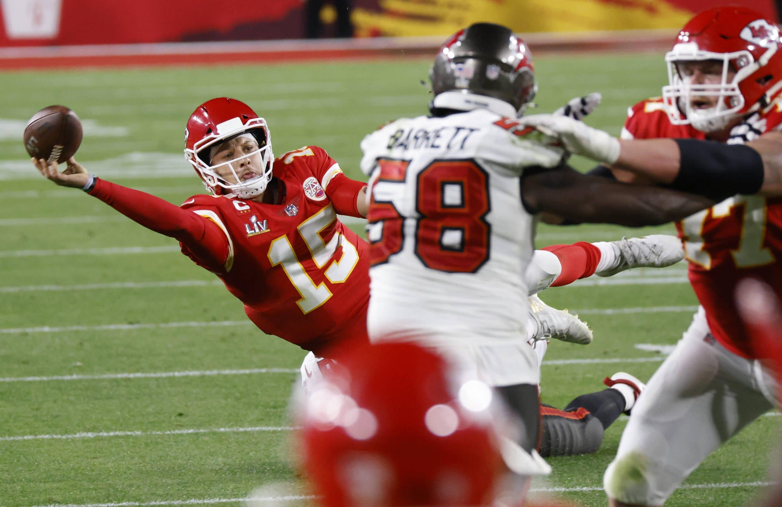 Kansas City Chiefs quarterback Patrick Mahomes (15) throws a desperation pass as he falls to the ground in the fourth qu