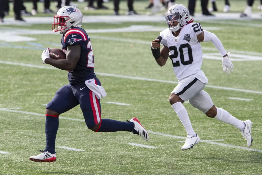 New England Patriots running back Sony Michel (26) runs up field while chased by Las Vegas Raiders cornerback Damon Arne