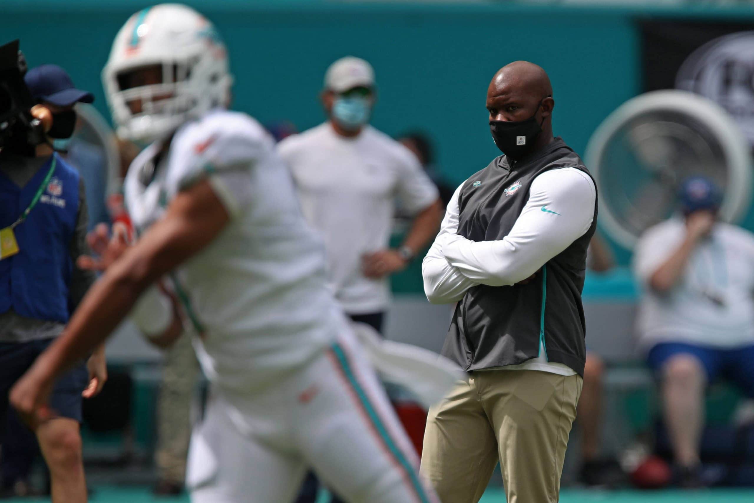 October 4, 2020, USA: Miami Dolphins coach Brian Flores watches quarterback Tua Tagovailoa warm up before their game aga