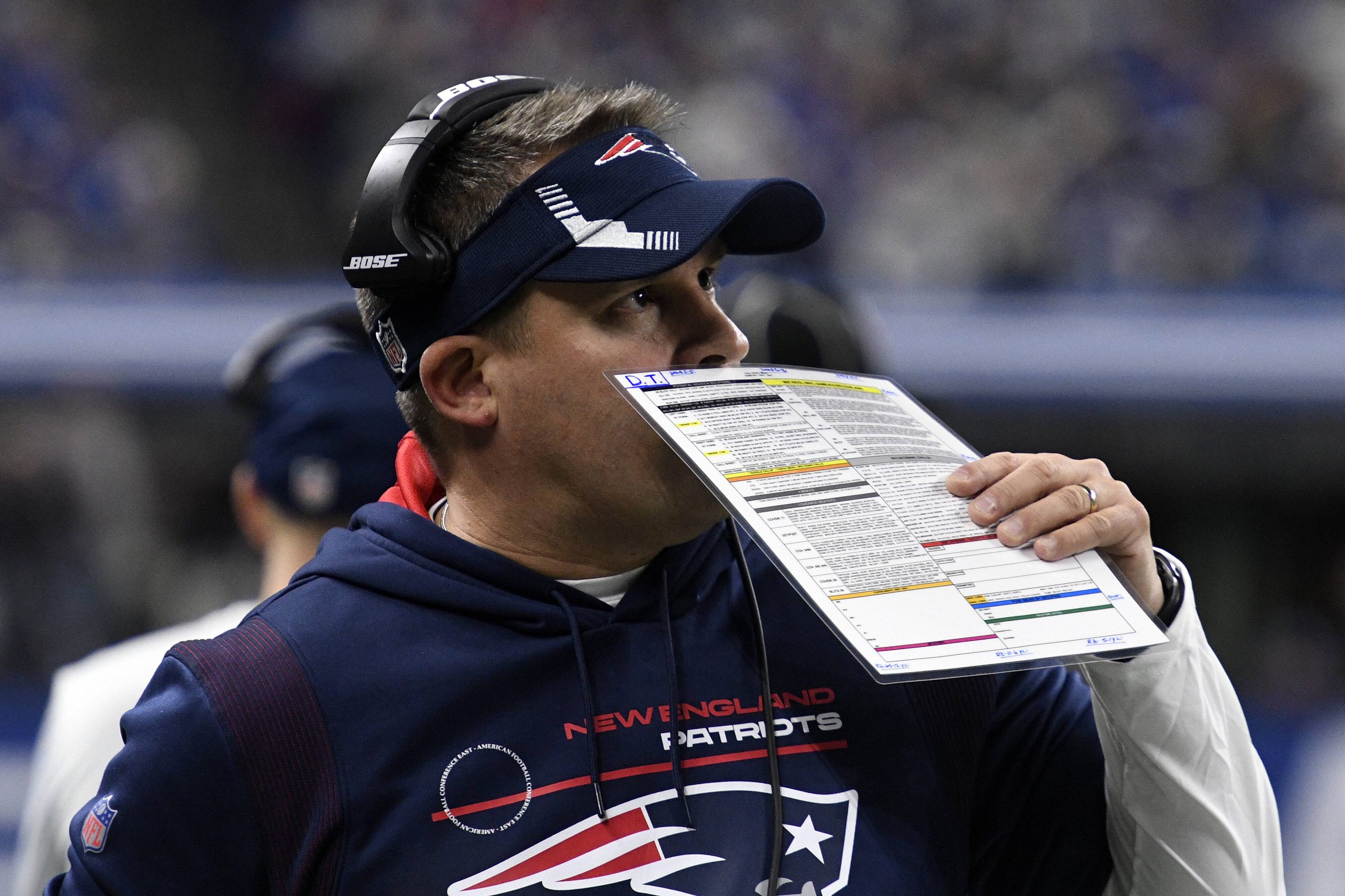 INDIANAPOLIS, IN - DECEMBER 18: New England Patriots offensive coordinator Josh McDaniels covers his mouth as he talks o