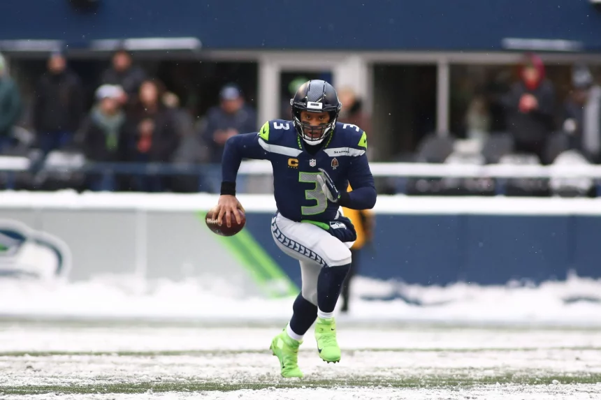December 26, 2021: Seattle Seahawks quarterback Russell Wilson (3) scrambles out of the pocket in the snow during a game