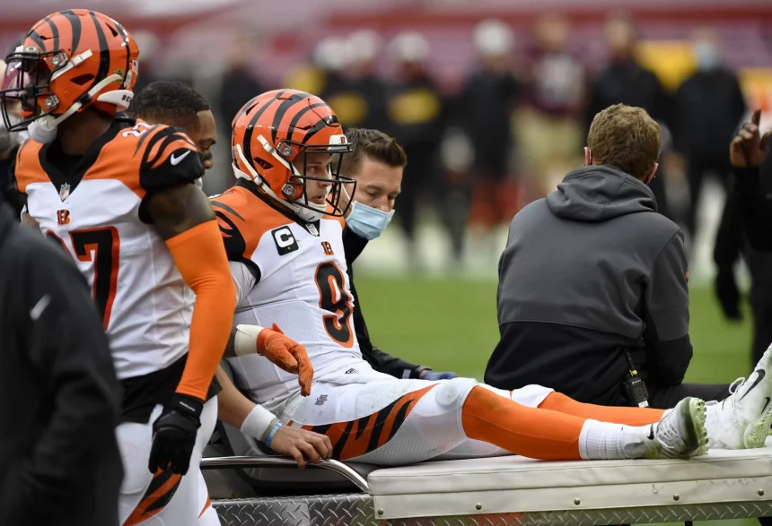 LANDOVER, MD - NOVEMBER 22: Joe Burrow (9) reacts as he is carted off the field after being injured during the Cincinna
