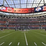 Workers make last minute preparations on the SoFi Stadium field for Sunday s LVI Super Bowl in Inglewood California on S