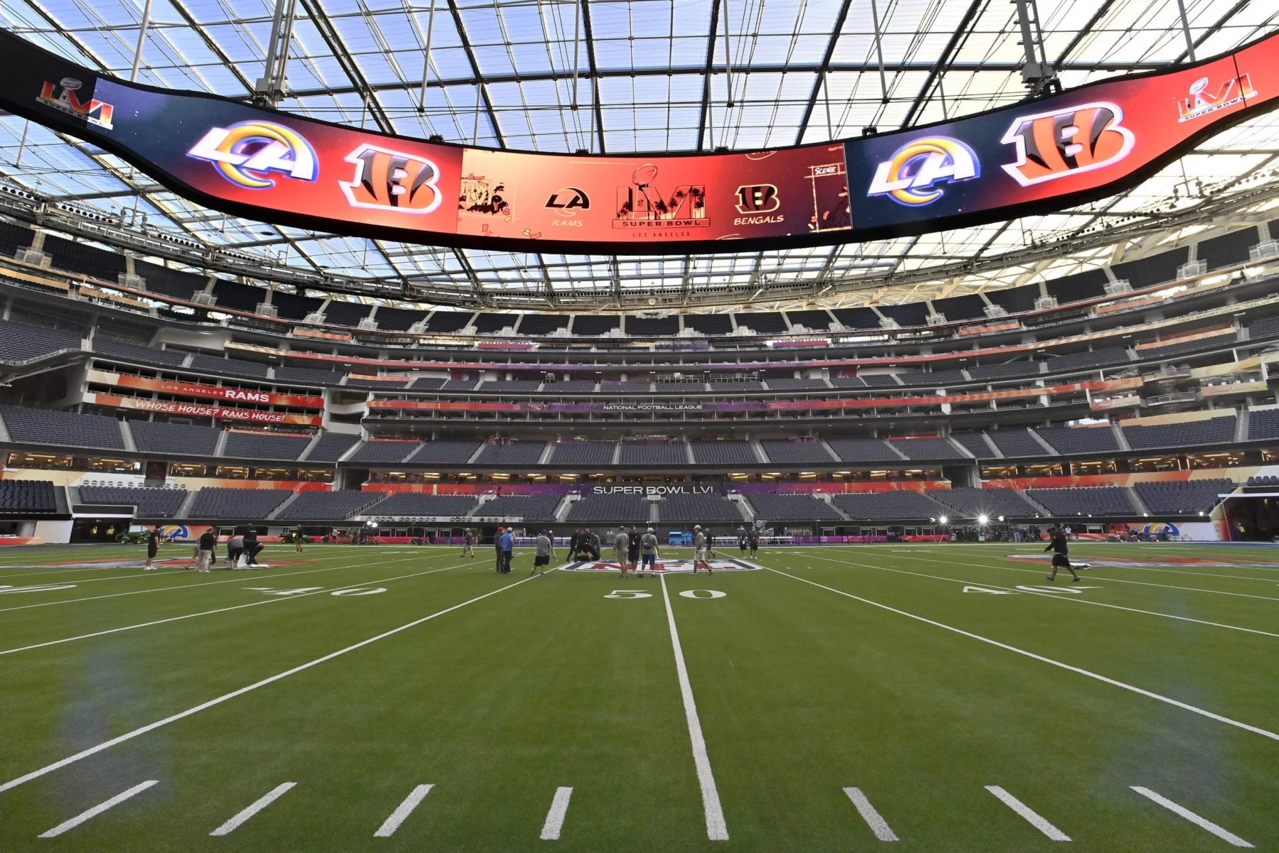 Workers make last minute preparations on the SoFi Stadium field for Sunday s LVI Super Bowl in Inglewood California on S
