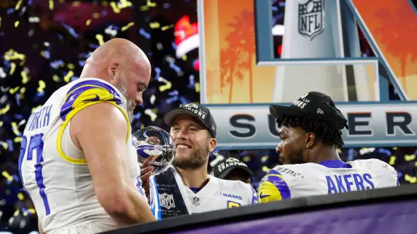 Los Angeles Rams offensive tackle Andrew Whitworth (L) holds the Vince Lombardi Trophy while celebrating with quarterbac