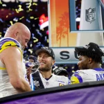 Los Angeles Rams offensive tackle Andrew Whitworth (L) holds the Vince Lombardi Trophy while celebrating with quarterbac