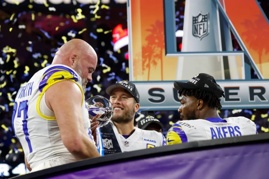 Los Angeles Rams offensive tackle Andrew Whitworth (L) holds the Vince Lombardi Trophy while celebrating with quarterbac