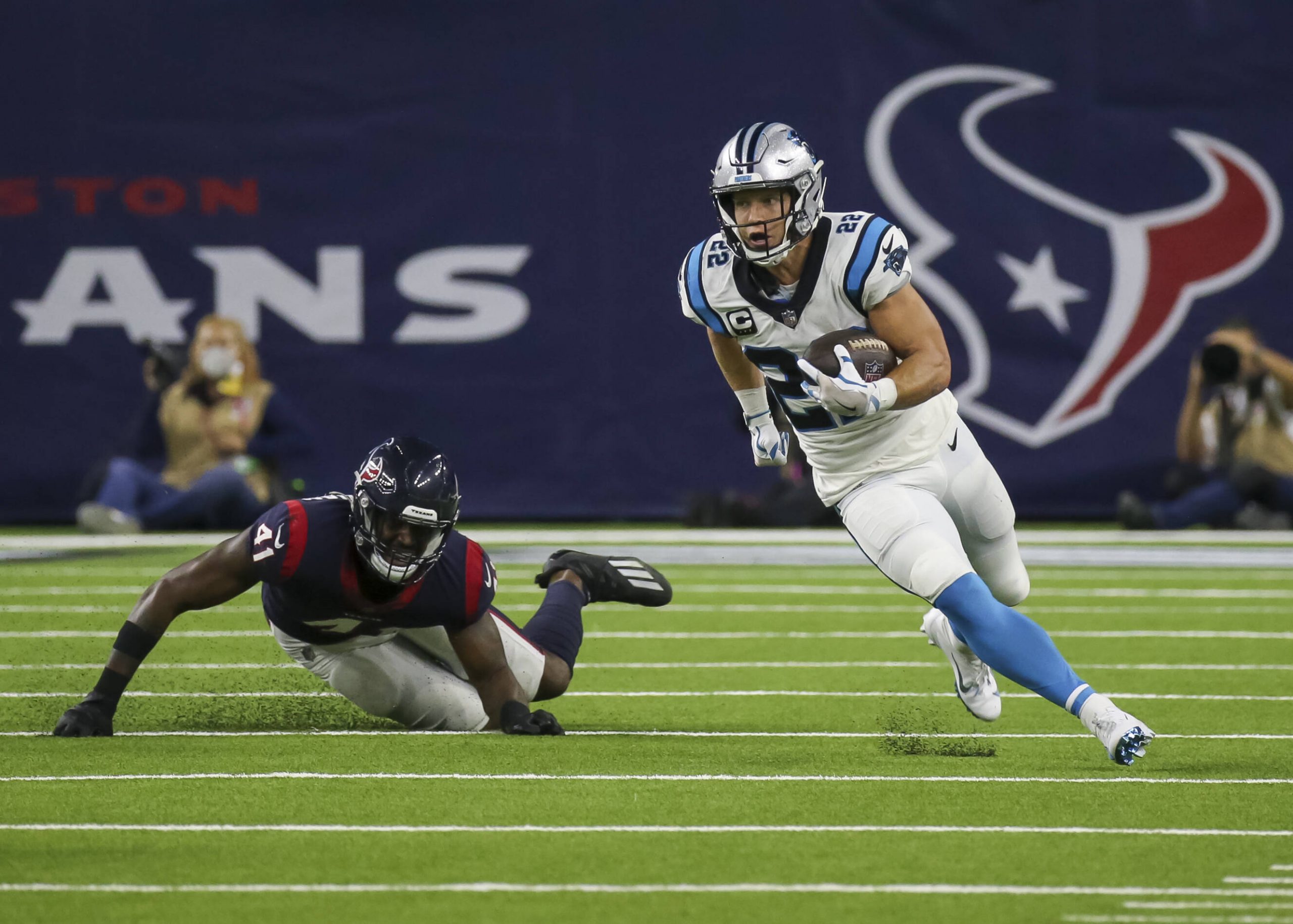 HOUSTON, TX - SEPTEMBER 23: Carolina Panthers running back Christian McCaffrey (22) evades a tackle by Houston Texans in