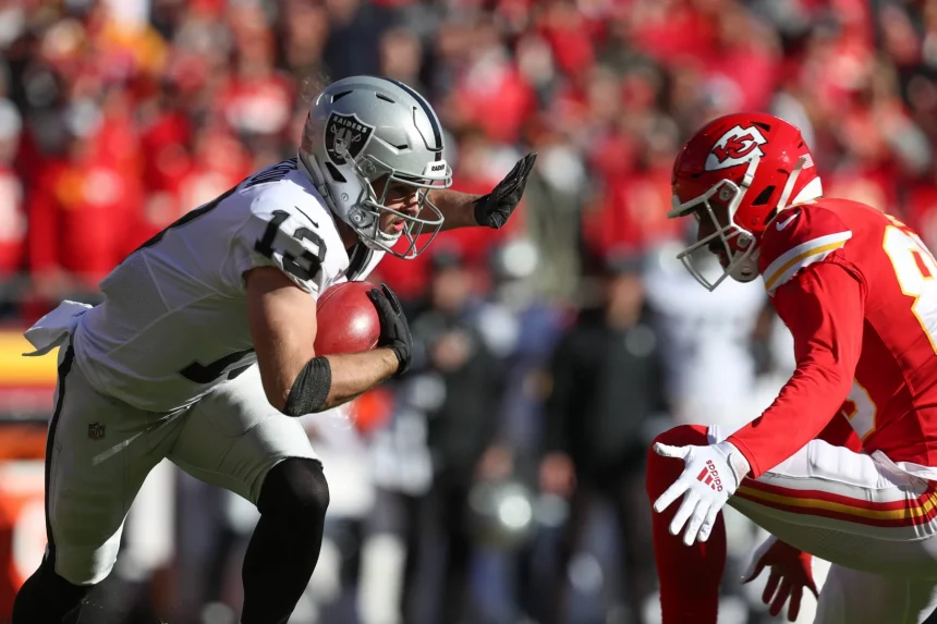 KANSAS CITY, MO - DECEMBER 12: Las Vegas Raiders wide receiver Hunter Renfrow 13 tries to stiff arm Kansas City Chiefs wide receiver Marcus Kemp 85 during a punt return in the first quarter of an NFL, American Football Herren, USA game between the Las Vegas Raiders and Kansas City Chiefs on Dec 12, 2021 at GEHA Field at Arrowhead Stadium in Kansas City, MO. Photo by Scott Winters/Icon Sportswire NFL: DEC 12 Raiders at Chiefs Icon2112120174