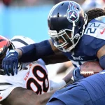 Tennessee Titans running back Derrick Henry 22 stiff-arms Cincinnati Bengals nose tackle D.J. Reader 98 during the first half of an NFL, American Football Herren, USA Divisional Playoff game at Nissan Stadium in Nashville, Tennessee, on Saturday, January 22, 2022. PUBLICATIONxINxGERxSUIxAUTxHUNxONLY NAS20220122106 DAVIDxTULIS