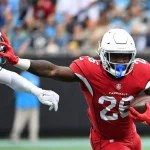 NFL, American Football Herren, USA Arizona Cardinals at Carolina Panthers Oct 2, 2022 Charlotte, North Carolina, USA Arizona Cardinals running back Eno Benjamin 26 with the ball as Carolina Panthers safety Jeremy Chinn 21 defends in the first quarter at Bank of America Stadium. Charlotte Bank of America Stadium North Carolina USA, EDITORIAL USE ONLY PUBLICATIONxINxGERxSUIxAUTxONLY Copyright: xBobxDonnanx 20221002_bsd_sd2_667