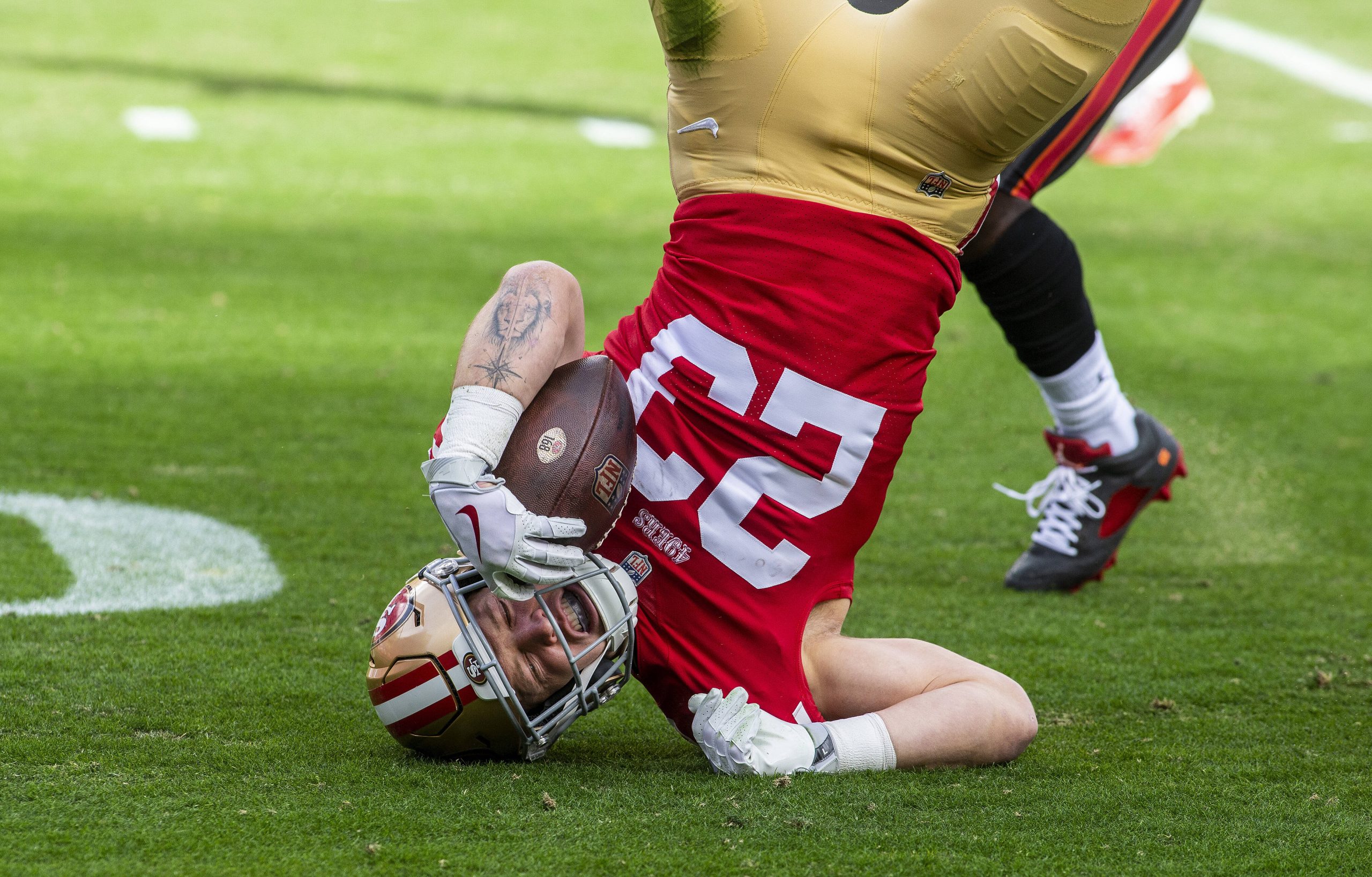 SANTA CLARA, CA - DECEMBER 11: San Francisco 49ers running back Christian McCaffrey 23 gets turned upside down rushing in the first quarter of an NFL, American Football Herren, USA game between the San Francisco 49ers and Tampa Bay Buccaneers on December 11, 2022, at Levis Stadium, in Santa Clara, CA. Photo by Tony Ding/Icon Sportswire NFL: DEC 11 Buccaneers at 49ers Icon46520221211025