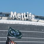 East Rutherford, New Jersey - Circa 2017: New York Jets football team flag waves in wind during parking lot tailgate outside Metlife Stadium before season game