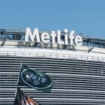 East Rutherford, New Jersey - Circa 2017: New York Jets football team flag waves in wind during parking lot tailgate outside Metlife Stadium before season game
