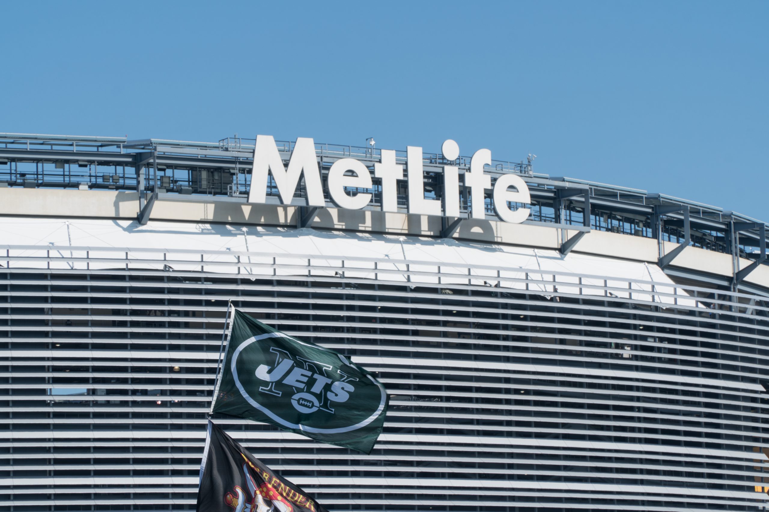 East Rutherford, New Jersey - Circa 2017: New York Jets football team flag waves in wind during parking lot tailgate outside Metlife Stadium before season game
