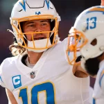 NFL, American Football Herren, USA Los Angeles Chargers at Denver Broncos Jan 8, 2023 Denver, Colorado, USA Los Angeles Chargers quarterback Justin Herbert 10 celebrates with wide receiver Keenan Allen 13 after a touchdown in the first quarter against the Denver Broncos at Empower Field at Mile High. Denver Empower Field at Mile High Colorado USA, EDITORIAL USE ONLY PUBLICATIONxINxGERxSUIxAUTxONLY Copyright: xIsaiahxJ.xDowningx 20230108_ijd_bd3_014