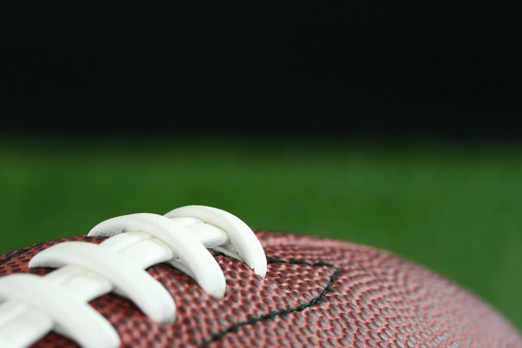 Football on a field at NFL Preseason