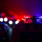 Police cars at night. Police car chasing a car at night with fog background. 911 Emergency response police car speeding to scene of crime. Selective focus