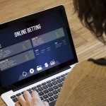 betting at home: close up view of woman using the computer to bet