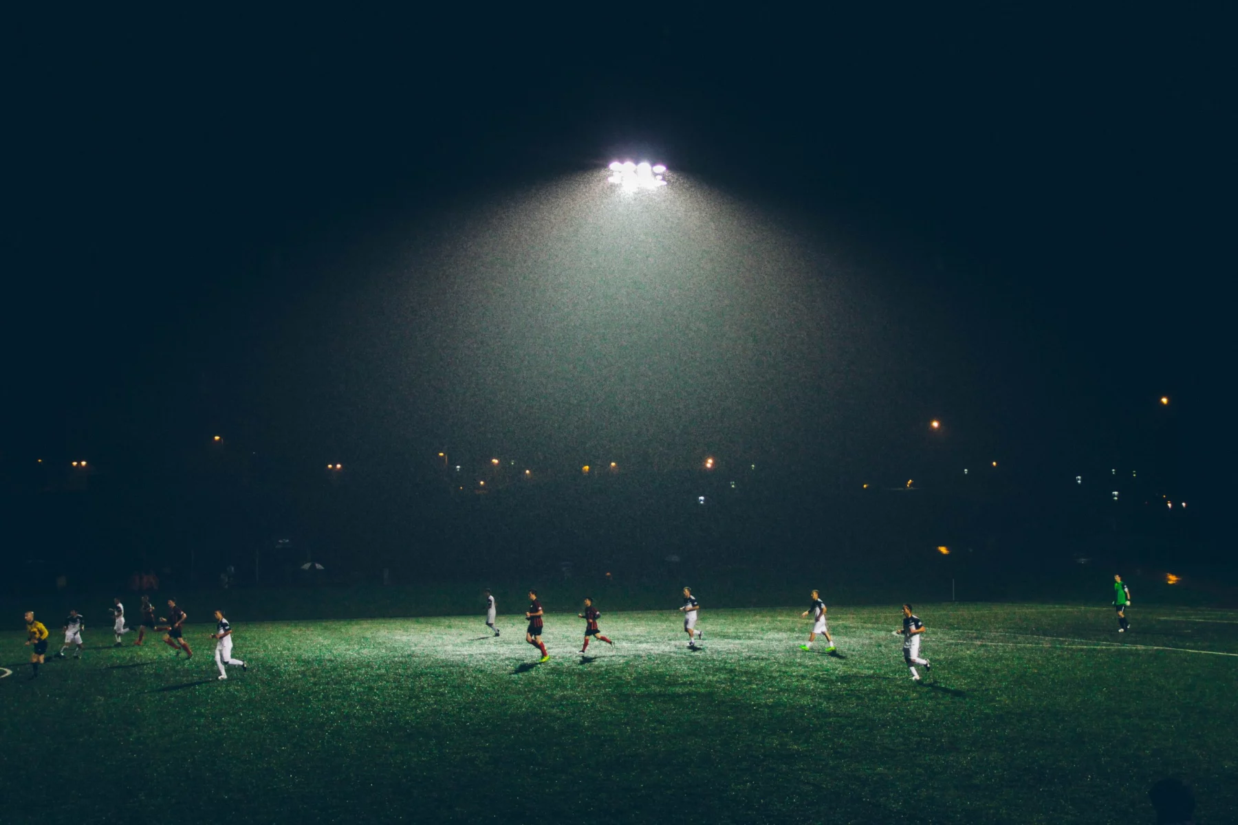 FootballR - NFL - Die großen Anwärter der Meisterschaft kämpfen unter den strahlenden Lichtern eines Fußballplatzes.
