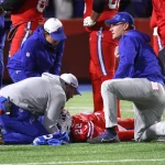 FootballR - NFL - Ein Footballspieler, Bills RB Damien Harris, wird auf dem Spielfeld behandelt und von einem Krankenwagen transportiert.