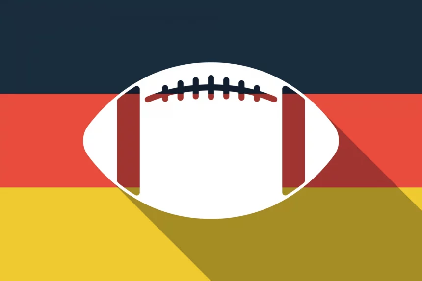 FootballR - NFL - Ein Football mit langem Schatten auf der Flagge Deutschlands bei den Frankfurt Games.