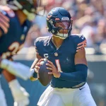 FootballR - NFL - Justin Fields, ein Quarterback der Chicago Bears, wirft den Ball in seinem Rückspiel gegen die Lions.