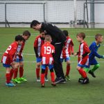FootballR - NFL - Eine Gruppe Kinder spielt Fußball auf einem Feld.