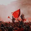 FootballR - NFL - Eine Menschenmenge, die in einer Stadt rote Fahnen schwenkt.