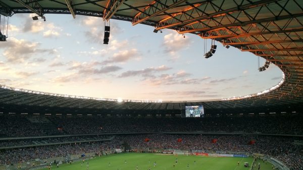 FootballR - NFL - Ein Fußballspiel in einem Stadion bei Sonnenuntergang.
