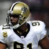 FootballR - NFL - Diese Beschreibung wurde automatisch generiert. Der Footballspieler der New Orleans Saints, Will Smith, trägt einen Helm.
