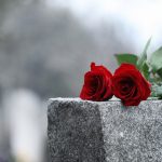 FootballR - NFL - Diese Beschreibung wurde automatisch generiert. Auf dem Grabstein von Tony Hutson sind zwei rote Rosen platziert.