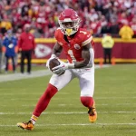 FootballR - NFL - Diese Beschreibung wurde automatisch generiert. Jerick McKinnon, ein Spieler der Kansas City Chiefs, läuft mit dem Ball.