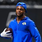 Footballspieler der Los Angeles Rams mit blauem Kapuzenpullover und Football in der Hand, blaue Kappe rückwärts getragen