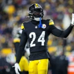 Joey Porter Jr. - Ein Footballspieler in einem schwarz-gelben Trikot der Porter Cowboys mit der Rückennummer 24 gestikuliert während eines Spiels auf dem Spielfeld. Alt-Text wurde KI-generiert.