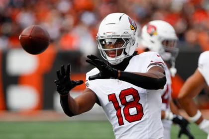 Marvin Harrison Jr - Der Wide Receiver mit der Nummer 18 der Arizona Cardinals streckt die Arme aus, um den Football zu fangen, während die Cardinals kurz vor einem Touchdown stehen. Alt-Text wurde KI-generiert.
