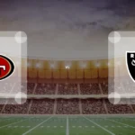 Eine Gamecard Grafik fuer das Spiel zwischen den San Francisco 49ers und Las Vegas Raiders am 28.08.26. die zwei Teamlogos stehen sich in einem Stadion mit vielen Zuschauern gegenueber.