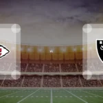 Eine Gamecard Grafik fuer das Spiel zwischen den Kansas City Chiefs und Las Vegas Raiders am 05.10.26. die zwei Teamlogos stehen sich in einem Stadion mit vielen Zuschauern gegenueber.
