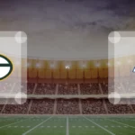 Eine Gamecard Grafik fuer das Spiel zwischen den Green Bay Packers und Los Angeles Rams am 26.11.26. die zwei Teamlogos stehen sich in einem Stadion mit vielen Zuschauern gegenueber.