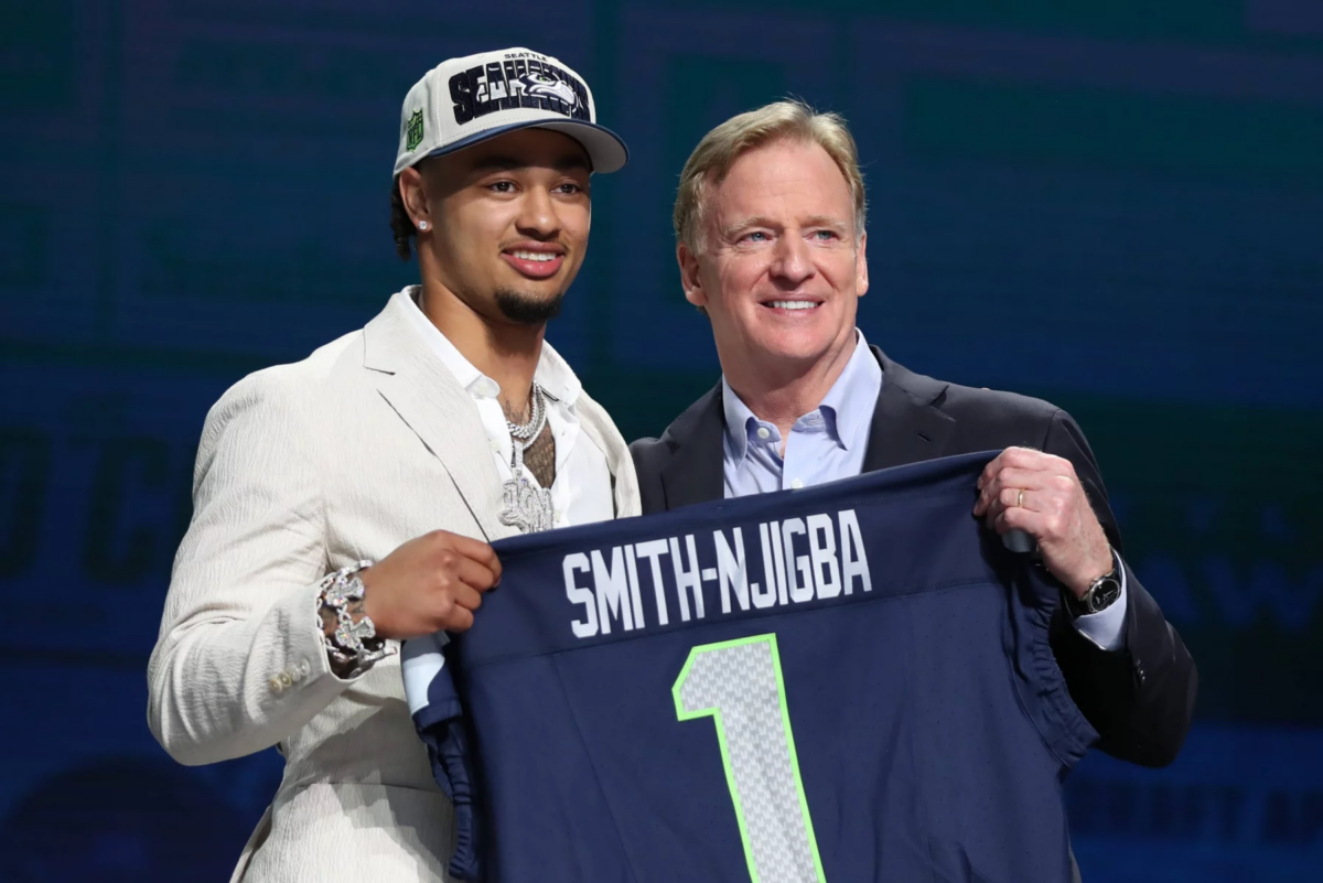 KANSAS CITY, MO - APRIL 27: Ohio State wide receiver Jaxon Smith-Njigba holds a jersey with commission Roger Goodell after being drafted in the first round of the NFL, American Football Herren, USA Draft on April 27, 2023 at Union Station in Kansas City, MO. Photo by Scott Winters/Icon Sportswire NFL: APR 27 2023 Draft EDITORIAL USE ONLY Icon2304270567